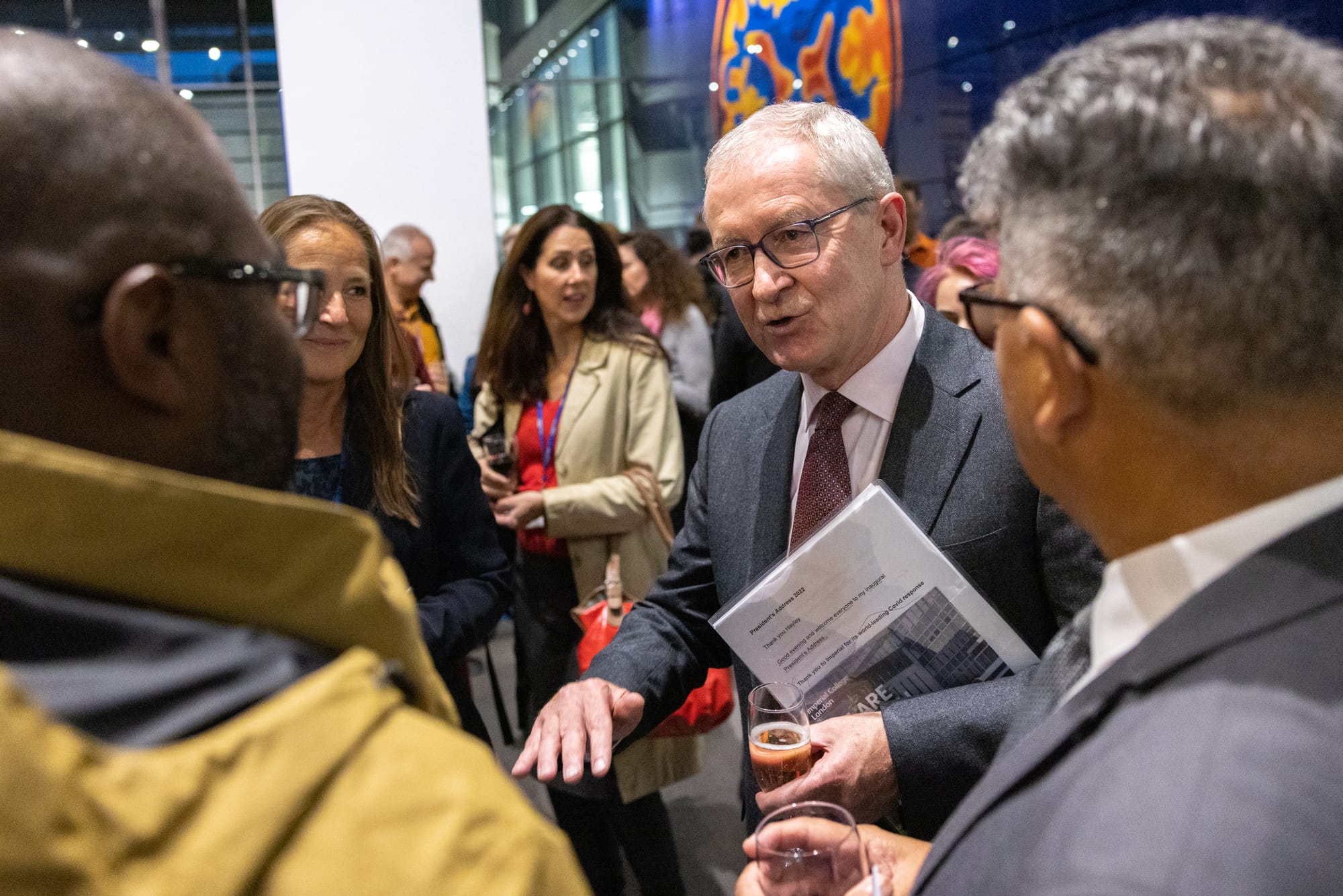 College President Hugh Brady talks to staff after his inaugural address