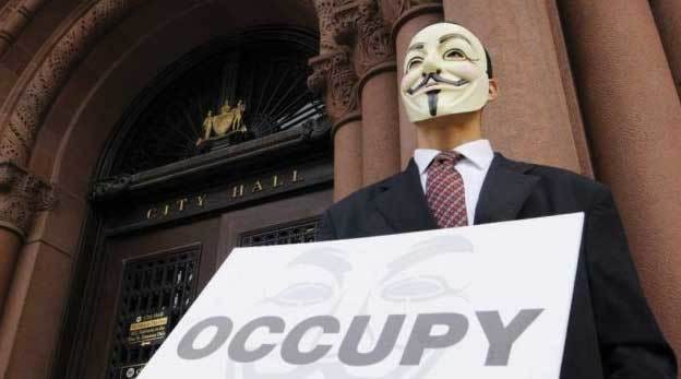 A random comrade with a Guy Fawkes mask (ironically, Guy Fawkes was a Catholic reactionary), occupying a City Hall somewhere