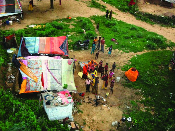 Waves and gazes of awe as the balloon soars over rural villages