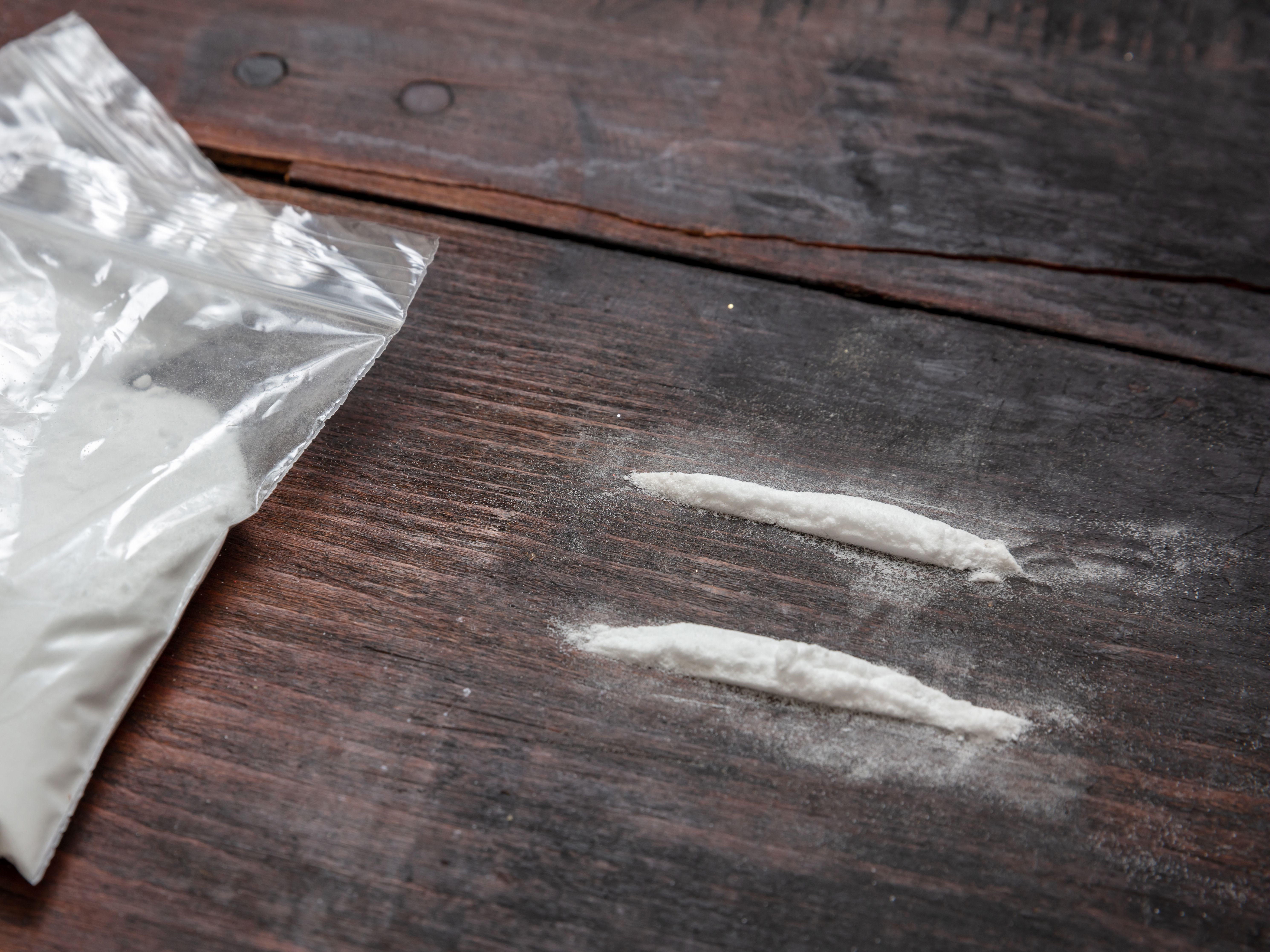 Cocaine Plastic Packets And Two Lines On Wooden Ta 2021 09 04 15 51 40 Utc