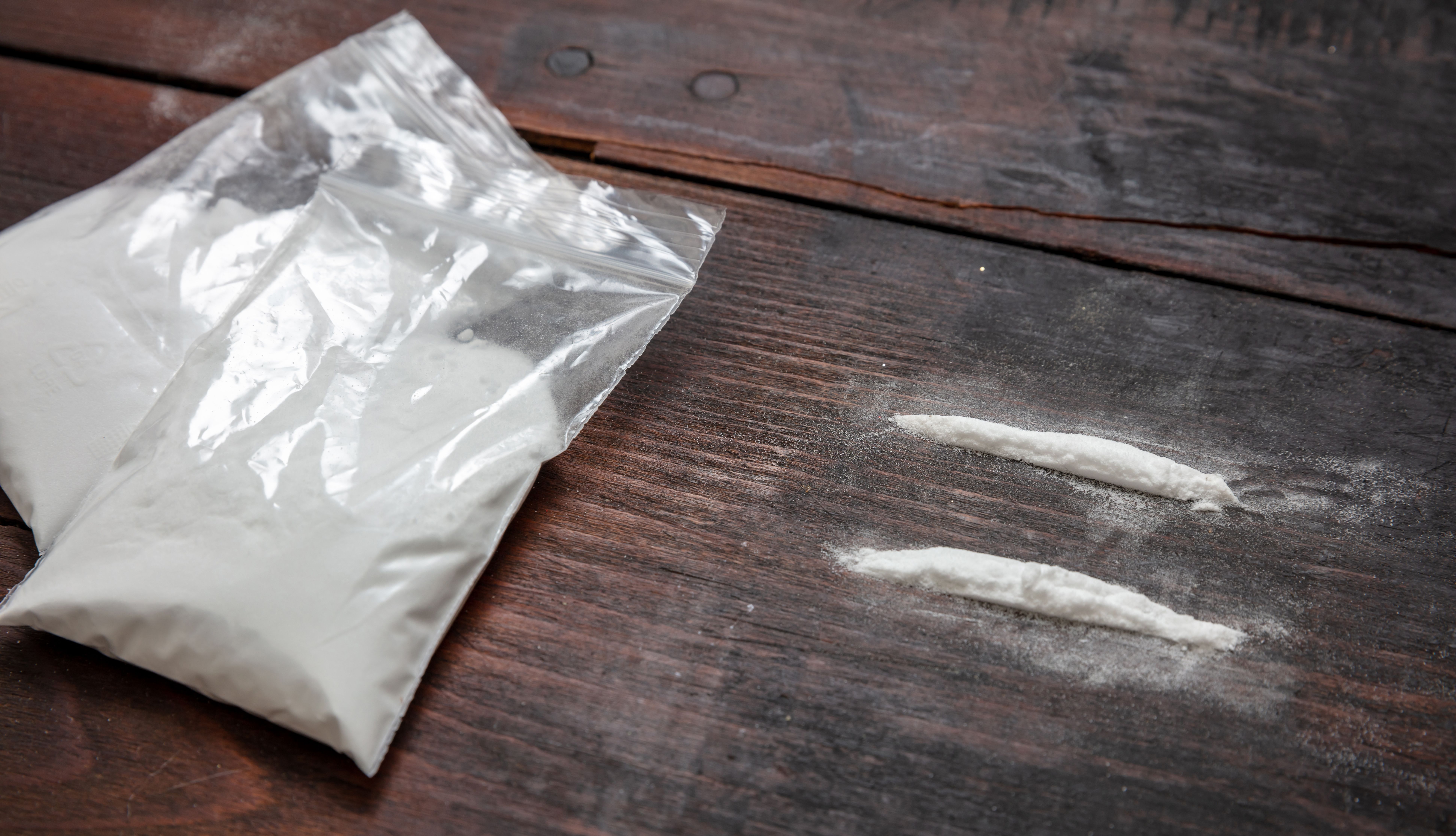 Cocaine Plastic Packets And Two Lines On Wooden Ta 2021 09 04 15 51 40 Utc